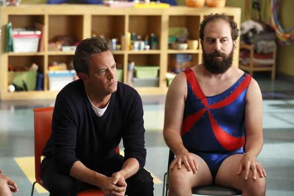 GO ON -- "Promo Coverage" -- Pictured: (l-r) Matthew Perry as Ryan, Brett Gelman as Mr. K -- Gymnast Shawn Johnson shoots promos with Matthew Perry and the cast of Go On. The promos will run during NBC's coverage of the Olympic games. -- (Photo by: Justin Lubin/NBC)